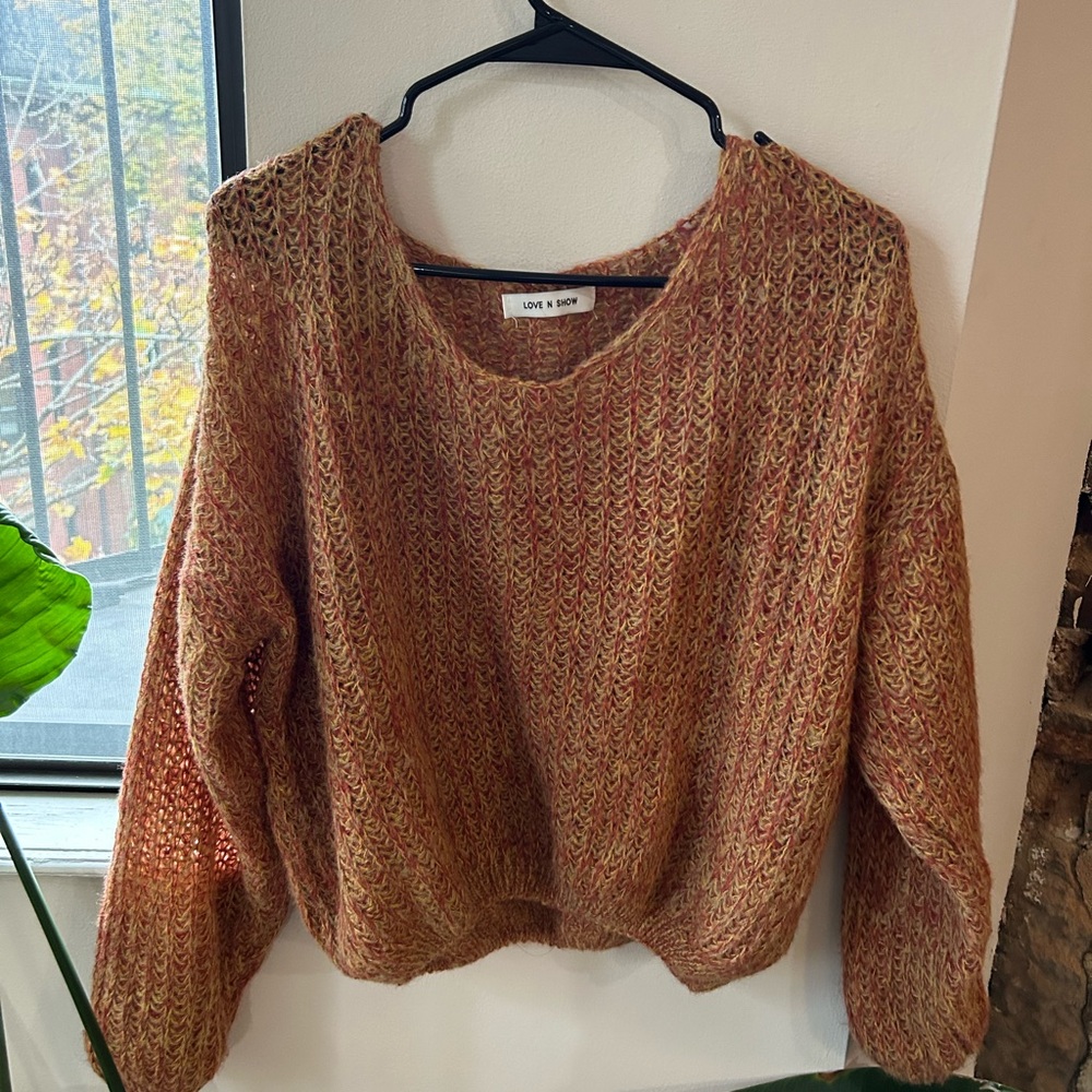 Lightweight orange knit sweater with a relaxed fit